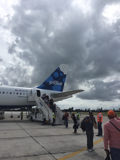 Graham Dancers board a Jet Blue flight to Cuba on a gray day